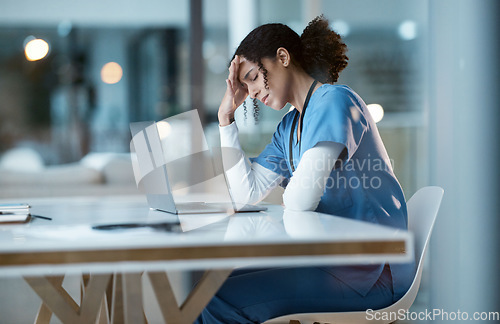 Image of Headache stress, nurse and black woman in hospital feeling pain, tired or sick on night shift. Healthcare, wellness or female medical physician with depression or burnout while working late on laptop