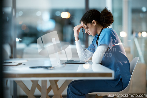 Image of Nurse, headache stress and black woman in hospital feeling pain, tired or sick on night shift. Healthcare, wellness or female medical physician with depression or burnout while working late on laptop