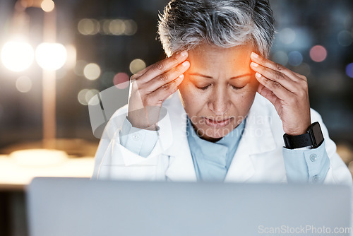 Image of Night, stress and headache with doctor at laptop for medical, stress and deadline review. Burnout, accountability and mental health with senior woman for healthcare, medicine and science research