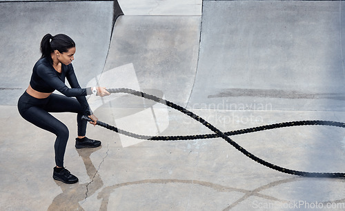 Image of Fitness, battle ropes and strong with a black woman athlete outdoor for a workout from above. Exercise, energy and power with a female training outside using a heavy rope for cardio or endurance