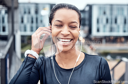 Image of Music, fitness and face of black woman with smile in city for wellness, healthy body and cardio workout. Sports, headphones and girl listening to audio for exercise, running and marathon training