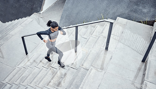 Image of Training, above and woman running on stairs for power, sports and body energy in the city. Challenge, exercise and athlete runner with cardio on steps for a marathon, health and workout performance