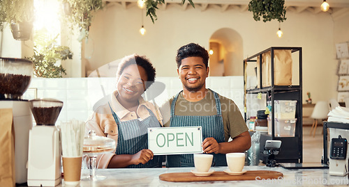 Image of Portrait, couple and open sign by restaurant owners happy at coffee shop or cafe in support together. Partnership, collaboration and team smiling due to startup growth and proud of success or vision