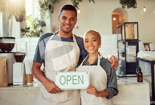 Image of Coffee shop, portrait and open sign by small business owners at a cafe in support together. Team, collaboration and friends smiling due to startup growth and proud of success or vision