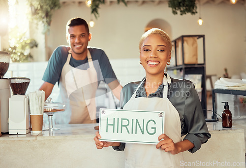 Image of Portrait, leader and hiring sign small business owner happy at coffee shop or cafe with employee. Team, collaboration and recruitment due to startup growth and vacancy to join us for a job