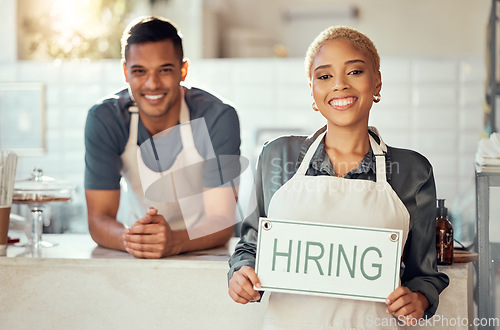 Image of Happy, partnership and hiring sign by small business owners at coffee shop or cafe in support together. Portrait, recruitment and vacancy at a startup with growth, join us or job or employment