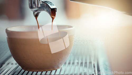 Image of Coffee machine, cup and restaurant with a caffeine beverage or espresso being poured in the service industry. Kitchen, cafe and drink with the pouring of a latte on a countertop for preparation