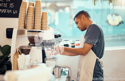 Image of Coffee shop, machine and man barista working on a espresso or latte order in the restaurant. Morning, cafeteria and male waiter from Mexico preparing a caffeine or tea warm beverage in a cafe.