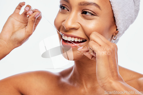 Image of Face, hands and black woman flossing teeth, dental health and hygiene isolated on white background. Oral care product, floss and mouth cleaning for fresh breath in studio with happy model