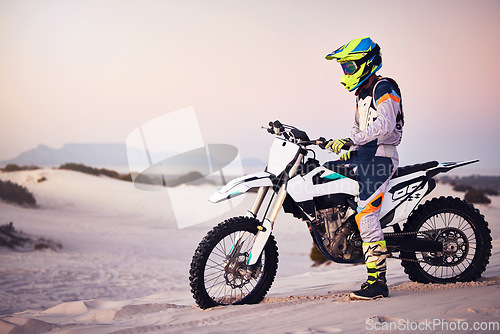 Image of Moto cross, sand landscape or man on bike stop for sport workout, sunset ride or exercise on hill. Nature, sky or male on motorcycle freedom adventure in Dubai desert for training, fitness or race