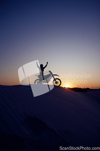 Image of Motorcycle, sport and silhouette of man winner on bike at night for exercise, wellness or workout in nature. Fitness sports, health or motorbike person celebrate on desert dirt sand or hill mountain