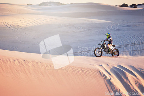 Image of Desert, moto cross and extreme motorbike sport of a man on sand dunes in Africa doing fitness. Driving challenge, beach adventure and cycling travel of a athlete in nature training for moto cross