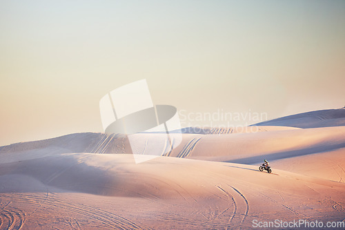 Image of Sand landscape, motorbike or man on moto cross in desert space for sport workout, sunset ride or exercise on hill. Nature, sky or man riding for speed adventure in Dubai for training, fitness or race