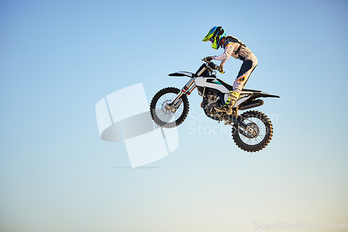 Image of Motorbike, jump and person on blue sky mockup for training, competition and challenge with safety gear. Professional cycling, motorbike and adventure with speed, sports and danger on mock up space