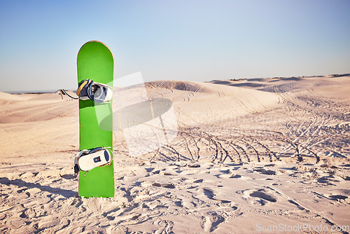 Image of Sandboard, sports and nature with desert sand, dunes and hills with no people and sport equipment. Exercise, fitness, and mockup of deserted landscape in Dubai with bike tracks and mock up space