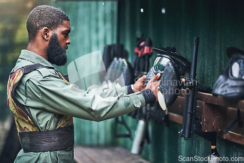 Image of Paintball man, prepare safety mask and clothes with gear, camouflage and start for outdoor combat game. African guy, war games or adventure for training, shooting or training for tactical development