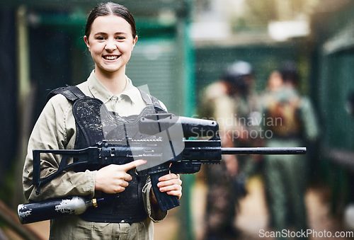 Image of Paintball, happy and portrait of woman with gun in safety uniform for outdoor shooting game with smile. Excited tournament girl in vest protection ready for shooter sport and activity.