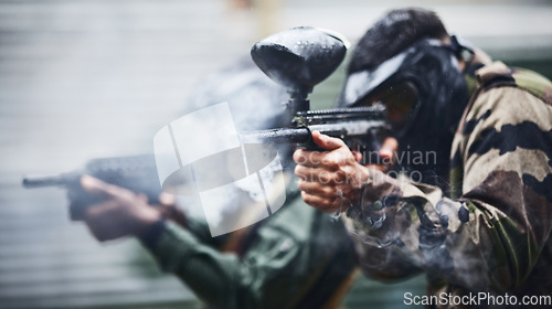 Image of Paintball, sports and smoke with gun for shooting, action and military battlefield with soldier, war and fitness outdoor. People together in camouflage, mask with weapon and game, power and lifestyle