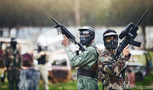 Image of Paintball, ready or people in a gun shooting games with war action in playground battlefield on holiday. Military mission, team or players with weapons gear for survival to start outdoor competition