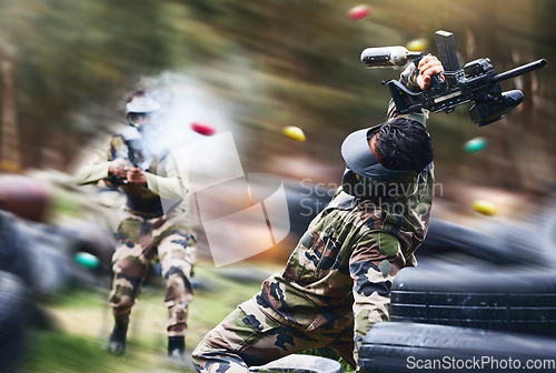 Image of Paintball, sport and action with gun for shooting, speed and military battlefield with soldier, war and fitness outdoor. People together in camouflage, mask with weapon and game, power and lifestyle
