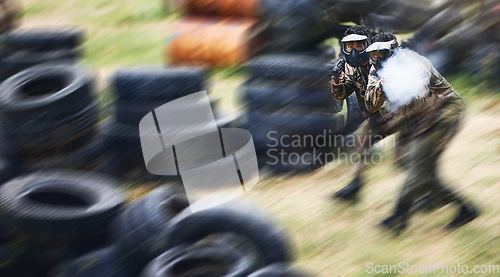 Image of Blurry, moving and team playing paintball with action, military clothes and running during a game in Australia. War, sport and friends with blurred motion during fun, playful and outdoor competition