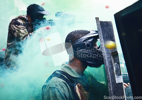 Image of Paintball team, shooting together and war game with shield, mask or tactical strategy for safety, competition or contest. Outdoor teamwork, team building and vision with weapon, combat and friends