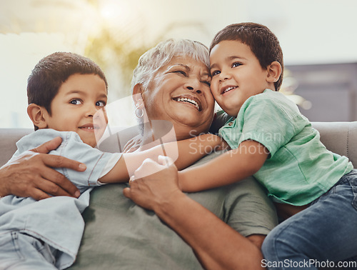 Image of Children, hug and grandmother on a sofa, happy and smile, love and laugh while bonding on their home visit. Kids, grandchildren and boy embrace grandma on a couch, relax and hugging in a living room