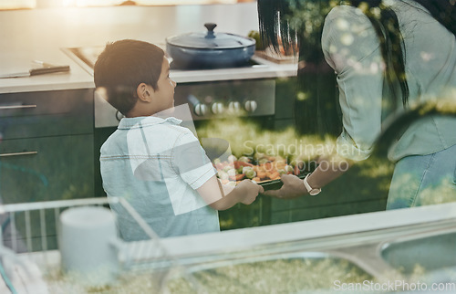 Image of Cooking, vegetables and child helping mother with food, preparation and learning by oven in kitchen. Breakfast, happy and mom and boy kid making lunch, dinner or a snack together in their family home