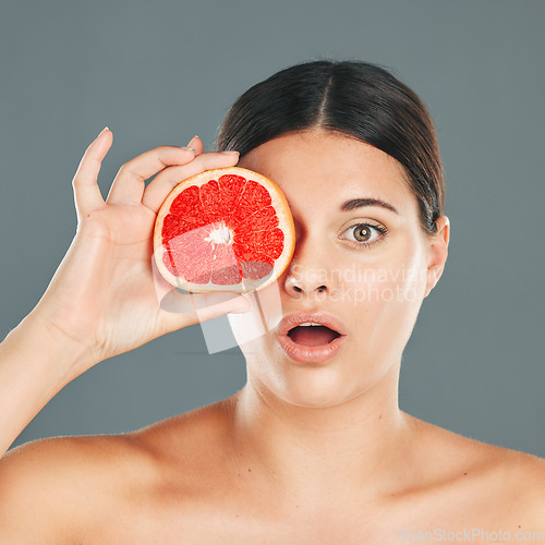 Image of Skincare woman with grapefruit portrait or wow face for health wellness, aesthetic or facial product. Healthy vitamin C, healthcare or nutrition with beauty, luxury or food in hand of model in studio