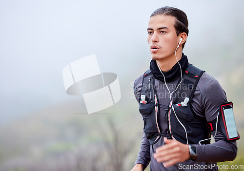 Image of Man, runner and exercise for training, outdoor or workout for health, wellness or morning routine. Headphones, male or athlete with sportswear, equipment for tracking or monitor heart rate and mockup