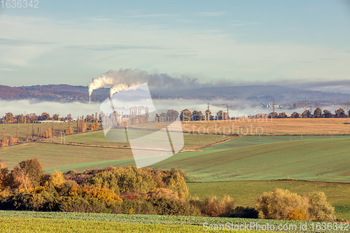 Image of industrial cityscape with with smoking factory