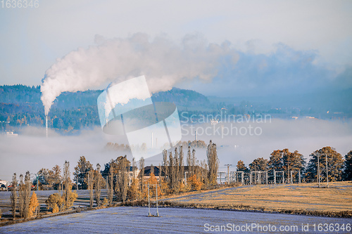 Image of industrial cityscape with with smoking factory