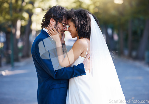 Image of Wedding, couple and love outdoor for marriage celebration event together with commitment. Happy interracial man and woman at park with trust, partnership and smile while touching face with care