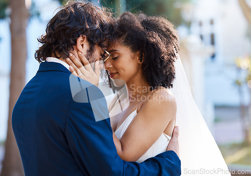 Image of Wedding couple, hug and love outdoor for marriage celebration event together with commitment. Happy interracial man and woman at park with trust, partnership and support with hands on partner face