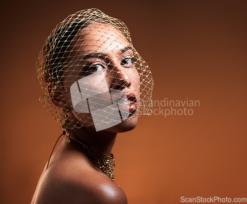 Image of Vintage, fashionable and portrait of a woman with a net veil isolated on a brown background in studio. Fashion, stylish and face of a young retro model with a classy facial accessory on a backdrop