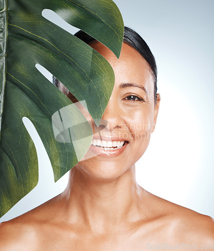 Image of Leaf, skincare and portrait of woman in studio for skin, product and natural treatment on grey background. Plant, beauty and face of girl model smile, happy or relax for vegan, cosmetic and isolated