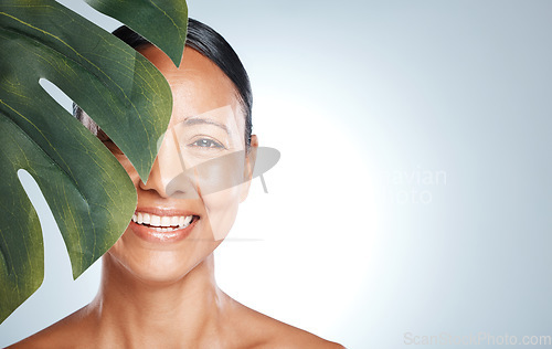 Image of Skincare, leaf and portrait of woman in studio for skin, product and natural treatment on grey background. Plant, beauty and face of model smile, happy or relax for cosmetic and isolated on mockup