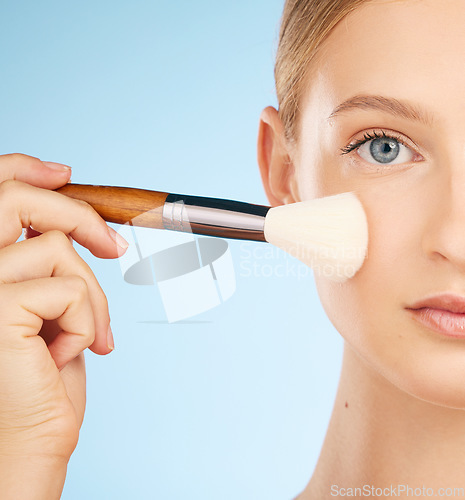 Image of Woman, studio portrait and makeup brush for cosmetics, foundation or beauty aesthetic by blue background. Healthy model, cosmetic application and natural skin glow with self care tools by backdrop