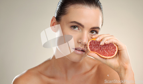 Image of Beauty, grapefruit squeeze and skincare woman portrait in studio with natural fruit cosmetic product. Face of model person with healthy vitamin c food for dermatology, skin glow and self care