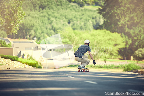 Image of Skateboard, road and mockup with a sports man skating or training outdoor while moving at speed for action. Fitness, exercise and street with a male skater or athlete outside to practice his balance