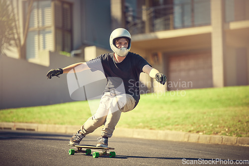 Image of Skateboard, training or mockup with a sports man skating on a street outdoor while moving at speed for action. Fitness, exercise and road with a male skater or athlete outside to practice his balance