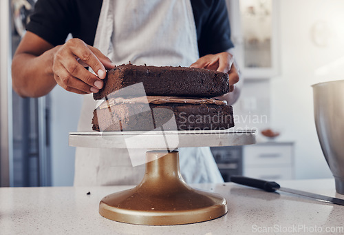 Image of Layering, preparation and hands of a man with a cake for a birthday, dessert and sweet treat. Kitchen, working and chef in a bakery baking food, confectionery and unhealhy snack on a counter