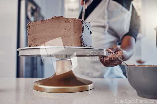 Image of Hand, cake and cooking with a man chef working in a kitchen while preparing dessert for a party celebration. Food, chocolate and cherries with a male at work in a bakery to make gourmet confectionary