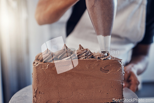 Image of Piping, bakery and hands of baking a chocolate cake in a kitchen or pastry chef cooking a recipe. Food, dessert and cook preparing a sweet meal in Brazil and adds cream from a bag