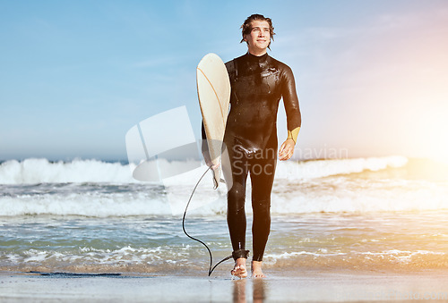 Image of Summer, thinking and man at the beach for surfing, training and happy by the waves in Hawaii. Water, travel and surfer with a board for sports, peace and idea with flare on vacation by the ocean