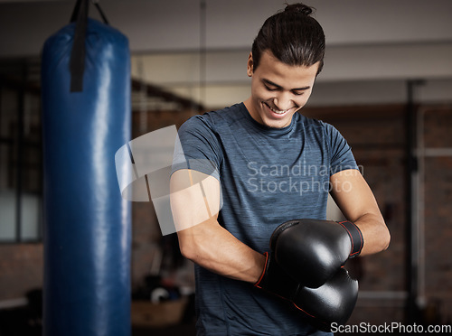 Image of Fitness, boxing and man with gloves in gym for sport training, exercise or challenge. Happy, smile and male athlete or boxer doing cardio kickboxing workout for health or wellness in sports studio.