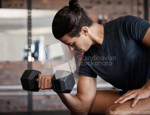Image of Fitness, bicep and dumbbell with a sports man training in a gym for strong or healthy muscles. Happy. exercise and weightlifting with a male athlete or bodybuilder in a health club for a workout