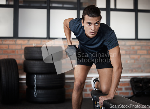 Image of Fitness, bench and dumbbell with a sports man training in a gym for strong or healthy muscles. Mindset. exercise and weightlifting with a male athlete or bodybuilder in a health club for a workout