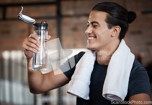 Image of Fitness, smile and drinking water with man in gym for health, exercise and cardio endurance. Wellness, weightlifting or training with body builder on break in sports center for stamina, detox or diet