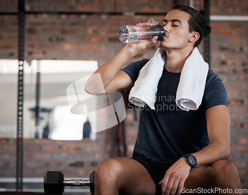 Image of Fitness, relax and drinking water with man in gym for health, exercise and cardio endurance. Wellness, weightlifting or training with body builder on break in sports center for stamina, detox or diet